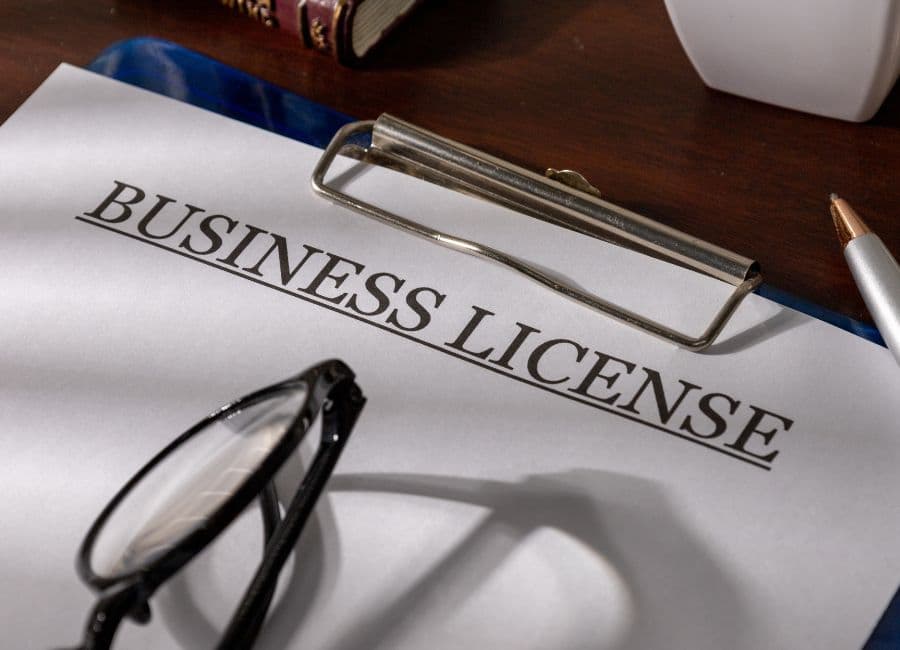 Dubai business setup meeting with licensing documents and a laptop